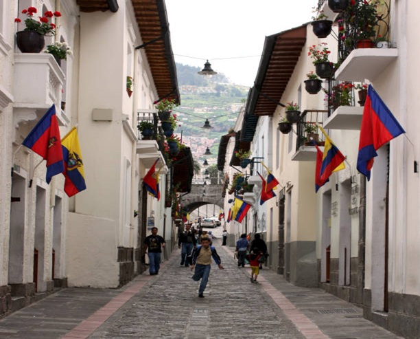 Quito, Ecuador; February 21, 2009: Calle La Ronda, is a typical colonial street in historic district. Some people walking and sitting at the rock street.